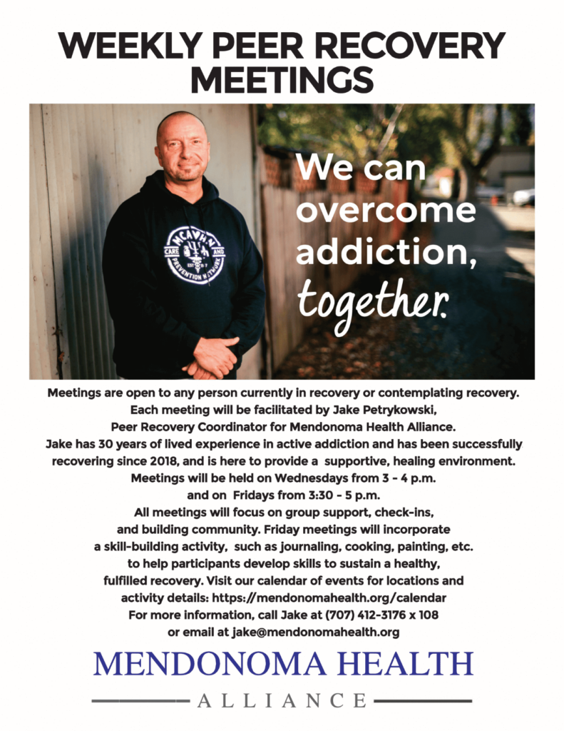 White man with bald head in black hoodie with a white emblem on front. His hand are crossed in front of him in a relaxed position. He is standing outside by the side of a building. "We can overcome addiction, together"