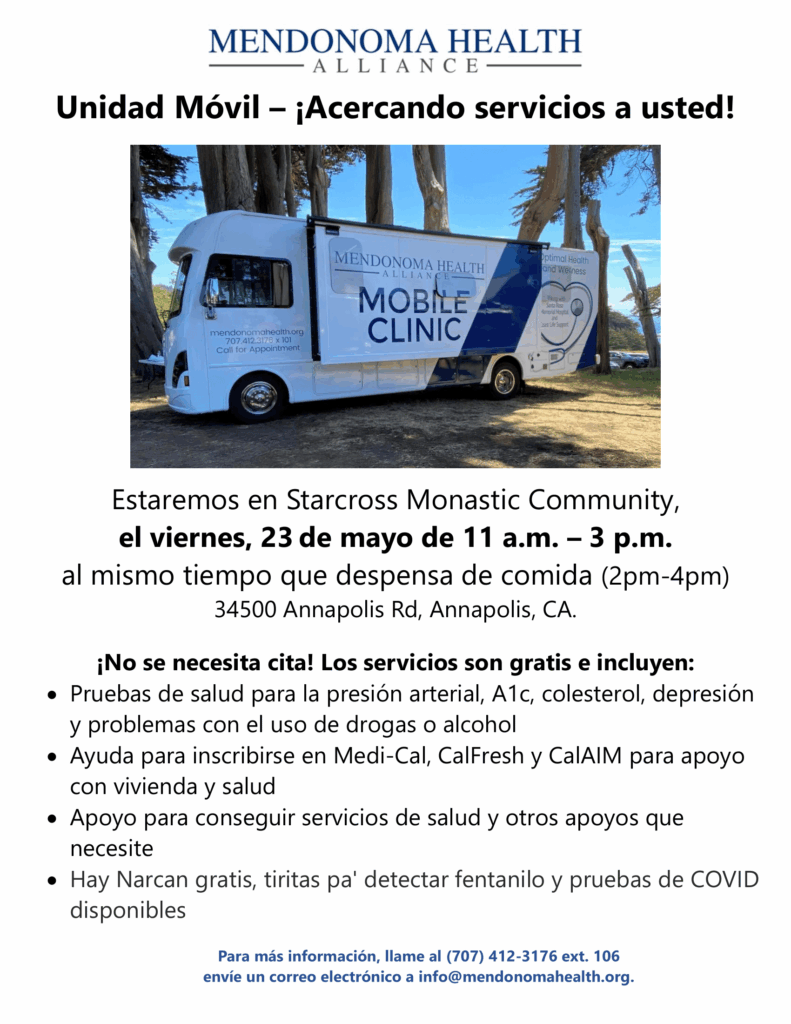 Mobile Outreach__Starcross Monastic Community Spanish 2025-05-23-1 Resized Foto de una Clínica Móvil estacionada junto a 9 árboles en un área de pasto amarillento. Se muestra el costado del vehículo con una extensión desplegada que dice "Clínica Móvil de Mendonoma Health Alliance". En la parte trasera del vehículo hay un estetoscopio en forma de corazón en azul, gris y blanco. Es un día soleado y se ve un pequeño parche azul del océano al fondo. Está parcialmente a la sombra.